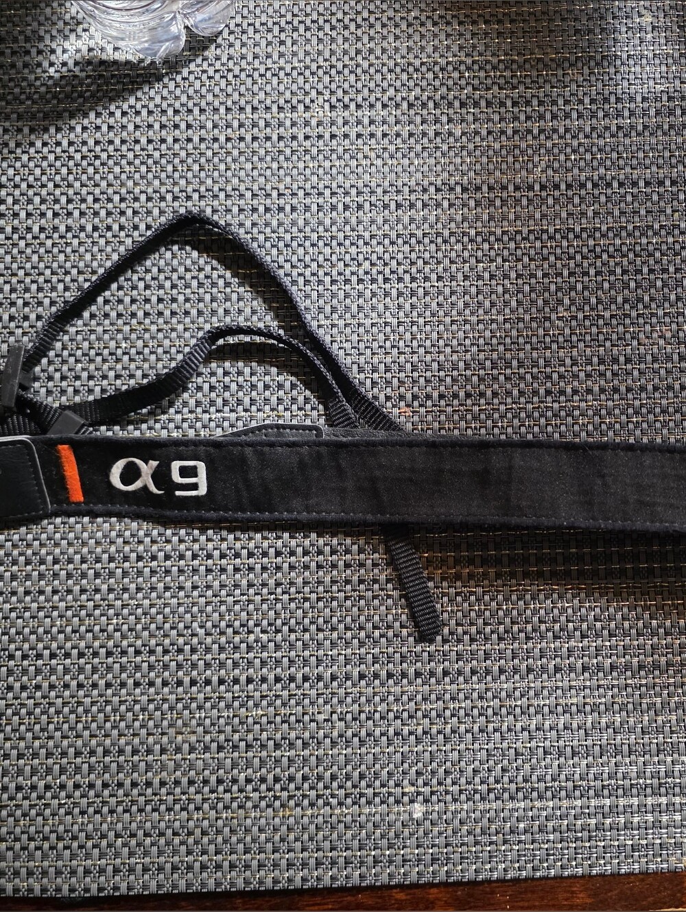 Sony Black Camera Strap with White Logo and Orange Accent